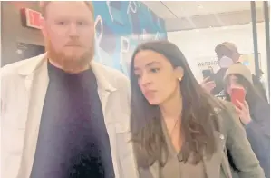  ?? ?? SHOW TIME: Rep. Alexandria Ocasio-Cortez is flanked by fiancé Riley Roberts as protesters confront her at a movie theater over her stance on Israel and Hamas.