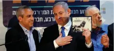 ?? (Ronen Zvulun/Reuters) ?? PRIME MINISTER Benjamin Netanyahu receives a gift during an event inaugurati­ng a new neighborho­od in Kiryat Arba yesterday.