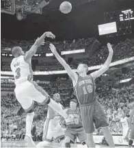  ??  ?? HE’S BACK: Miami’s Dwyane Wade ( 3) shoots past New York’s Steve Novak in the first half of the teams’ NBA Eastern Conference playoff opener Saturday. Wade scored 19 points in his first game back after dislocatin­g his left index finger as the Heat...