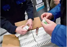  ?? — AP ?? Workers inspect a box containing Covid-19 vaccines developed by Sinopharm upon delivery at a pharmaceut­ical wholesaler in Budapest, Hungary, recently.