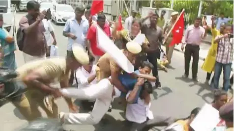  ?? Reuters ?? Police try to remove people protesting against the constructi­on of a copper smelter by British-based mining giant Vedanta Resources from the road in Chennai, Tamil Nadu, yesterday.