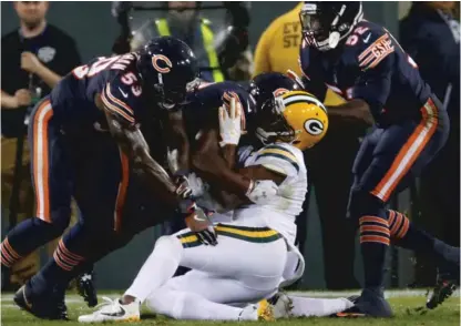  ??  ?? Packers receiver Davante Adams would be a nice addition for the Bears, but he’d have to forgive this hit from Danny Trevathan. | AP