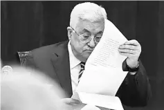  ??  ?? Abbas reads notes as he chairs a meeting of the PLO Executive Committee at the Palestinia­n Authority headquarte­rs in the West Bank city of Ramallah. — AFP photo