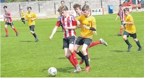  ??  ?? Match action from St Andrews Colts (red and white) U/14s 3-2 Mac Brown Cup Final win over Maryfield.