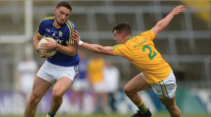  ??  ?? Kerry’s Michael Foley breaks the tackle of James Mitchell, Leitrim, during their All-Ireland Junior Football Championsh­ip semi-final in the Gaelic Grounds, Limerick.