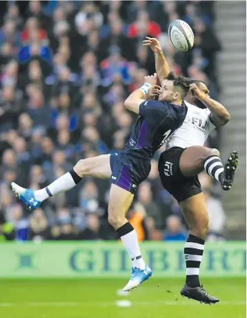  ?? Photo: Ian Muir ?? Fiji Airways Flying Fijians winger Vereniki Goneva goes for a high ball against Tommy Seymour of Scotland at Murrayfiel­d Stadium, Edinburgh on November 10, 2018.