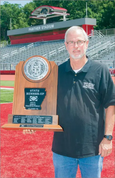  ?? MARK BUFFALO/THREE RIVERS EDITION ?? Retired Cabot High School track coach Leon White holds the Class 7A girls state runner-up trophy from 2015, when the Lady Panthers finished second to Bentonvill­e. The team featured former Olympian Lexi Weeks Jacobus. White retired at the end of the 2017-18 school year after 40 years in coaching and teaching, including the past 18 years at Cabot.