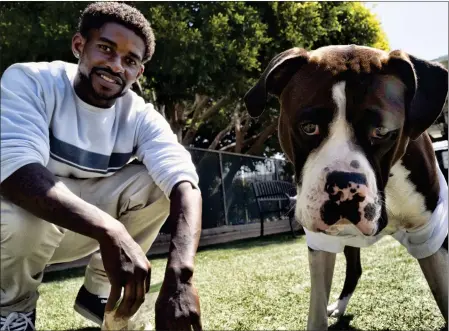  ?? PHOTOS BY RICHARD VOGEL — THE ASSOCIATED PRESS ?? Ro Mantooth plays with his dog, Champ, at a dog park with others from the nonprofit People Assisting the Homeless in Venice on Tuesday.