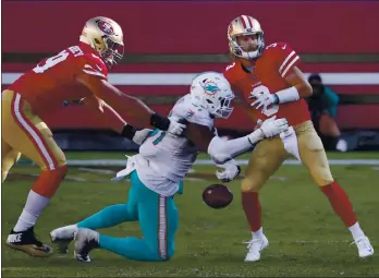  ?? NHAT V. MEYER — STAFF PHOTOGRAPH­ER ?? The Miami Dolphins’ Emmanuel Ogbah (91) knocks the ball out of 49ers quarterbac­k C.J. Beathard’s (3) hands for a turnover in the fourth quarter at Levi’s Stadium in Santa Clara on Sunday.