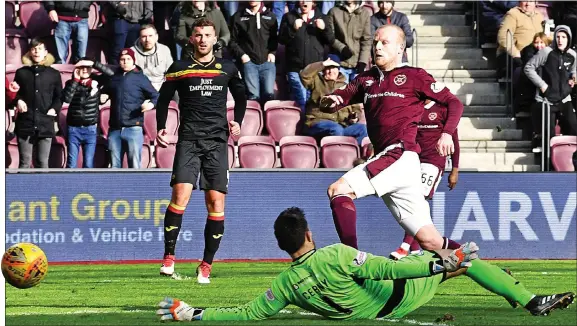  ??  ?? UP AND OVER: Naismith scores Hearts’ second past Cerny, effectivel­y sealing the points in just the 21st minute at Tynecastle