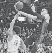  ?? Julie Jacobson / Associated Press ?? Duke’s Jayson Tatum soars over North Carolina’s Joel Berry II to score two of his 24 points Friday.