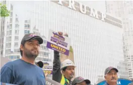  ?? MAXHERMAN/ FOR THE SUN- TIMES ?? Chicago window washers gather across from Trump Tower to announce they will strike after June 30 if necessary.