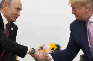  ??  ?? President Donald Trump (right) shakes hands with Russian President Vladimir Putin during a bilateral meeting on the sidelines of the G-20 summit in Osaka, Japan, on Friday. AP Photo/SuSAn WAlSh