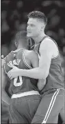  ?? AP/TONY DEJAK ?? Boston Celtics’ Avery Bradley (0) celebrates with Jonas Jerebko (8) after Bradley hit the game-winning shot against the Cleveland Cavaliers on Sunday night. Bradley’s shot gave the Celtics a 111-108 victory, cutting Cleveland’s series lead to 2-1.