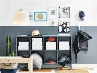  ?? PHOTO COURTESY OF IKEA ?? A cubby with storage space, a rack for hats and backpacks, and a stylish light fixture plus some art on the wall combine to create a stylish, welcoming entryway or mudroom.