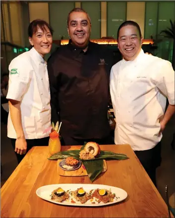  ?? RAY CHAVEZ — STAFF PHOTOGRAPH­ER ?? Chef Michael Mina, center, and renowned Hawaiian chefs Michelle Karr-Ueoka and Wade Ueoka opened their new Trailblaze­r Tavern inside the Salesforce East building in San Francisco last month.