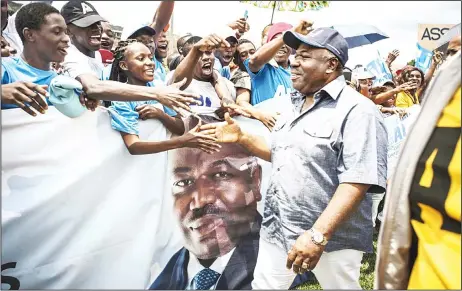  ??  ?? Incumbent Gabonese President Ali Bongo Ondimba greets supporters in Moanda on Aug 23. The one round presidenti­al elections in Gabon to be held on Aug 27, will oppose Gabonese President Ali Bongo Ondimba to the former president of the Commission of the...