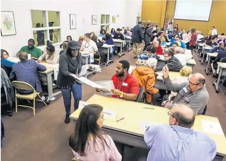  ?? /(JACOB LANGSTON/ORLANDO SENTINEL ?? Orange County Elections workers go through the hand recount of ballots at the Orange County Supervisor Of Elections office on Friday morning, November 16, 2018.