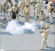  ??  ?? A policeman fires a tear gas shell at protesting farmers on Republic Day at ITO in New Delhi.