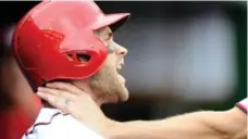  ?? GREG FIUME/GREG FIUME/GETTY IMAGES ?? Nationals outfielder Bryce Harper is grabbed by teammate Jonathan Papelbon during a dugout confrontat­ion on Sunday.