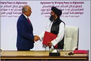  ??  ?? File photo of the deal signed in Doha between US special envoy Zalmay Khalilzad and Taliban political chief Mullah Abdul Ghani Baradar on 29 February.