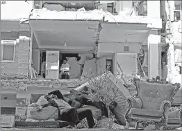  ?? AFP ?? An Iranian lies atop mattresses outside damaged buildings near the Iraq border.