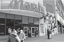  ?? Michael M. Santiago / Getty Images ?? People walk into a Marshalls store last week in New York City. New data shows that a year after the pandemic forced states to revise their revenue forecasts, for many the worst didn’t come.