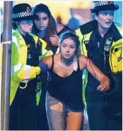  ?? Picture: LNP ?? Bomb victim Martyn, above, his mother Figen, right, and a survivor is led away by police at the arena