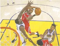  ?? JOHN G. MABANGLO/POOL PHOTO VIA AP ?? Rockets forward Trevor Ariza shoots against Warriors forward Draymond Green on Saturday in Oakland, Calif. The Warriors won 115-86 and forced Game 7 in the Western Conference Finals.
