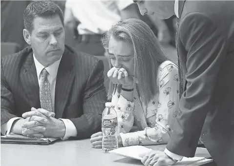  ?? GLENN C. SILVA, AP ?? Michelle Carter, flanked by defense attorneys Joseph Cataldo, left, and Cory Madera, is found guilty of involuntar­y manslaught­er Friday in the suicide of Conrad Roy III in Bristol Juvenile Court in Taunton, Mass. Carter could face up to 20 years in...