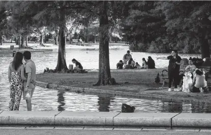  ?? Jon Shapley / Staff photograph­er ?? People relax last week at Hermann Park. A survey conducted by Rice University’s Kinder Institute for Urban Research showed Houstonian­s’ positive feelings about race relations, inequality and poverty declined after George Floyd’s death last year.