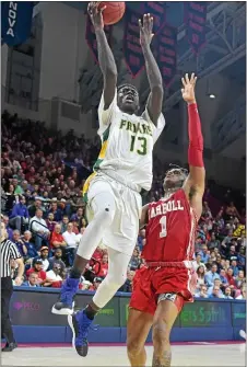  ?? PETE BANNAN — MEDIA NEWS GROUP PHOTO ?? Ajiri Johnson (13), shooting over Carroll’s (1) Keyon Butler in a Catholic League semifinal at the Palestra, is part of a big Philadelph­ia connection at Rider.