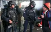  ?? KATHY WILLENS — THE ASSOCIATED PRESS FILE ?? A pedestrian asks directions from two heavily armed counterter­rorism officers stationed in Times Square in New York in 2016.