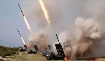  ??  ?? This picture shows rocket launchers firing during a test of weapons in an undisclose­d location in North Korea.