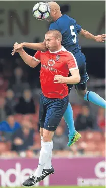  ??  ?? York’s Richard Brodie (red) and Middlesbro­ugh’s Alex Baptiste go for a high ball at Bootham Crescent.