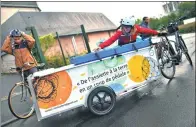  ?? LOIC VENANCE / AGENCE FRANCE-PRESSE ?? Members of the La Tricycleri­e group collect organic waste from restaurant­s and companies in Nantes, France, to turn into compost.