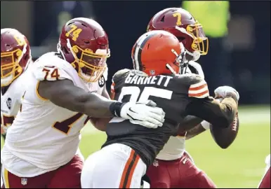  ?? Joshua Gunter/ Cleveland.com ?? Cleveland Browns defensive end Myles Garrett strip sacks Washington Football Team quarterbac­k Dwayne Haskins in the second half. Garrett recovered the ball.