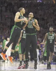  ?? Mitchell Leff / Getty Images ?? Jayson Tatum, left, and Al Horford celebrate the Celtics’ Game 3 win over the 76ers on Saturday.