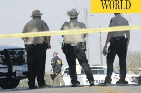  ?? ERICH SCHLEGEL / GETTY IMAGES ?? Police gather near the First Baptist Church following a shooting Sunday in Sutherland Springs, Texas. At least 26 people were reportedly killed and between 10 and 15 injured when a gunman, identified as Devin P. Kelley, 26, entered the church during a...