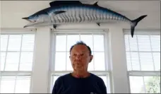  ??  ?? In this Nov. 2, 2017 photo, Jim Motsko, founder of the White Marlin Open fishing tournament, stands in his home in Ocean City, Md. “I kind of call it the velvet hammer,” Motsko said of the use of lie-detector tests in fishing tournament­s. “You need...