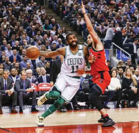  ?? CARLOS OSORIO/TORONTO STAR ?? Celtics guard Kyrie Irving tries to drive the baseline against the Raptors’ Fred VanVleet during first-half action Tuesday night at the ACC.