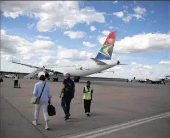  ??  ?? Passengers board an SAA aircraft at the Hosea Kutako Internatio­nal Airport outside Windhoek. An oversight committee is to look into the possible involvemen­t of a private partner in the affairs of the embattled national carrier.