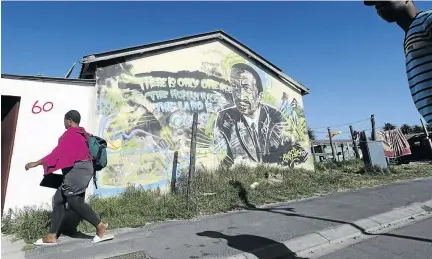  ?? /ADRIAN DE KOCK ?? An image of former PAC leader and intellectu­al Robert Sobukwe looms large in the street artwork in Langa township, Cape Town.