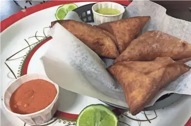  ?? MILWAUKEE JOURNAL SENTINEL ?? Menu items at the Somali restaurant African Garden include sambusas.