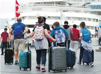  ?? RICHARD LAM ?? Cruise ship passengers arrive at Canada Place. The Port of Vancouver is expecting 32 ships to make 241 separate calls on Vancouver this season with 895,000 passengers, a seven per cent jump from 2017.