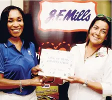  ??  ?? Lisa Tomlinson (right), sponsorshi­p and events manager at Continenta­l Baking Company, collects her second-place prize from Donna-Kaye Sharpe, trade marketing and distributi­on manager at JF Mills.