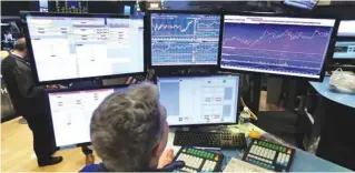  ??  ?? NEW YORK: Specialist Anthony Rinaldi works at his post on the floor of the New York Stock Exchange on Friday. — AP