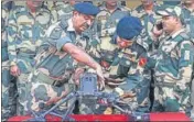  ?? AFP ?? BSF commandant Jasbir Singh (C) and other officers showing the drone downed near the border outpost of Daoke in Amritsar on Saturday.