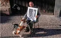  ??  ?? Truffle hunter Giovanni Monchiero poses with a picture of his grandfathe­r Giovanni Monchiero.