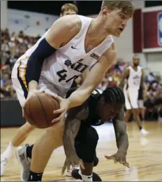  ?? AP PHOTO/JOHN LOCHER ?? Utah Jazz’s Isaac Haas, (left), battles for the ball with Portland Trail Blazers’ Archie Goodwin during the second half of an NBA summer league basketball game on Saturday, in Las Vegas.